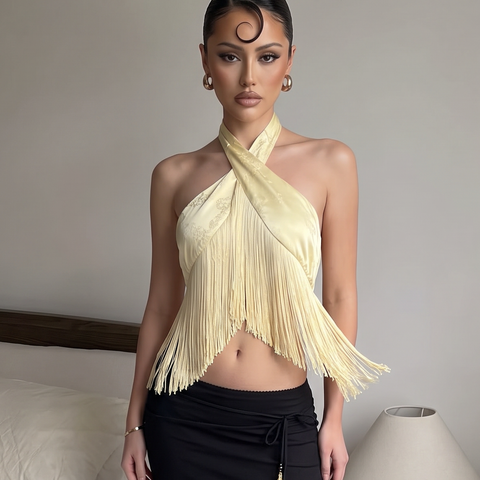 Butter yellow fringe halter top featuring a crisscross neckline and asymmetrical hem.
